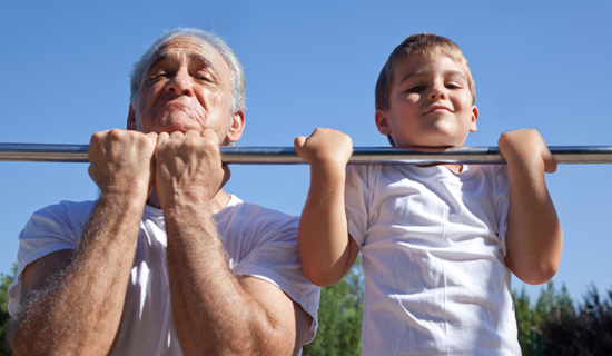a senior man and a child doing chin up