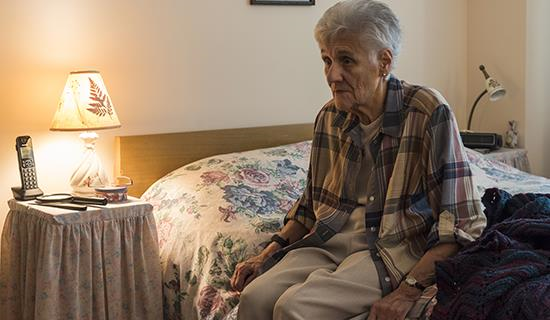 An elderly woman sitting in bed