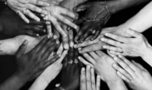 multi race hands holding in solidarity