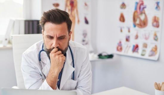 male doctor in medical office looks concerned