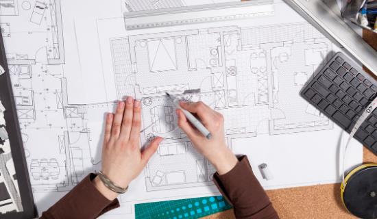 architect blueprints being edited by hand