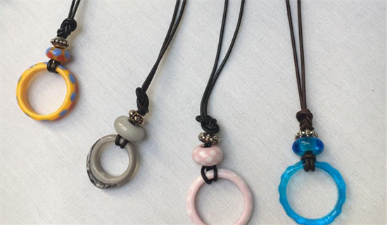four necklace with aech a ring of color, yellow, grey, pink, blue