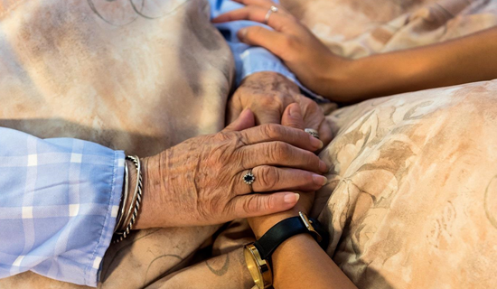 patient and loved one holding hands