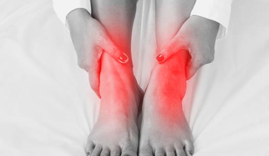 feet with ankle pain in red