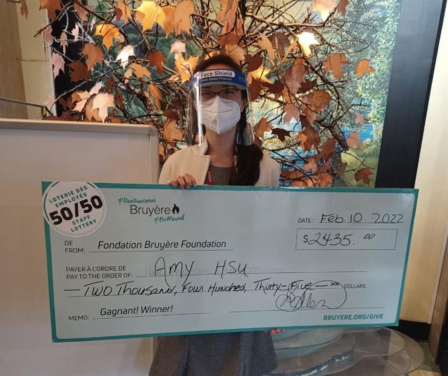 Photo of Amy Hsu with big cheque