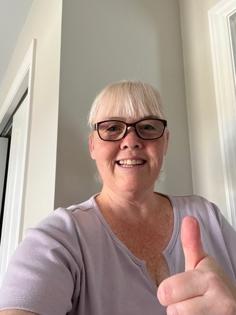 Photo of winner Kerri O'Malley smiling while giving a thumbs up