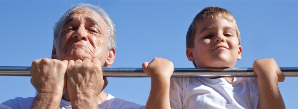 Older man and grandson doing chin-ups