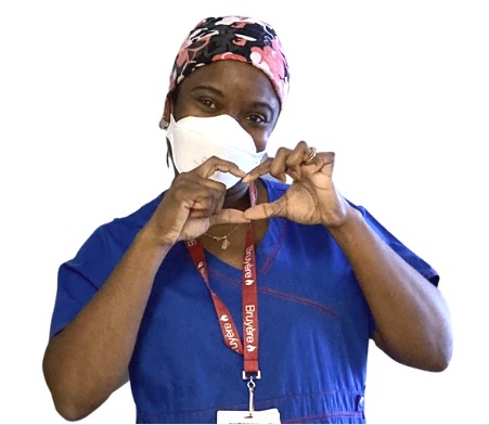 nurse making heart symbol with her hands