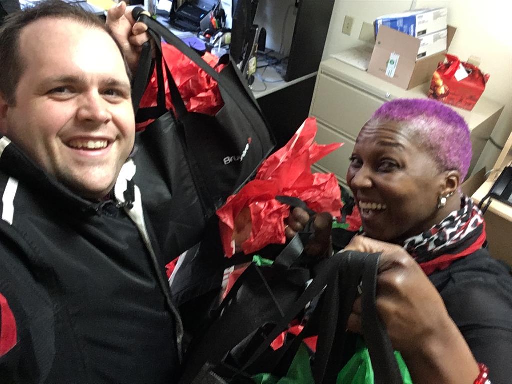 a man and a woman holding gift bags