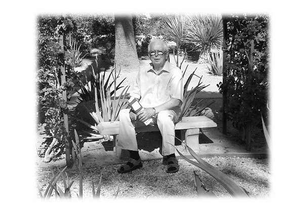 Black and white image of a senior man sitting on a bench