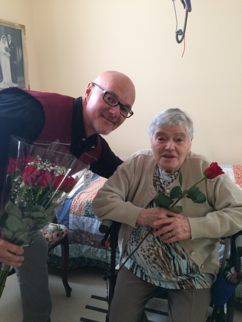 Michel, volunteer, gives a rose to a long-term care resident