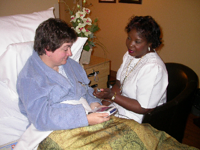 Patient in bed receiving care from a nurse